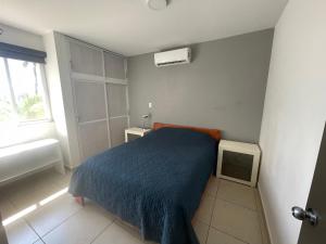Un pat sau paturi într-o cameră la Departamento Mazatlán MBOV