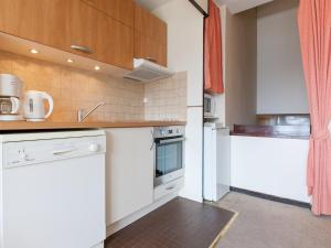 a kitchen with white appliances and wooden cabinets at Appartement Avoriaz, 3 pièces, 7 personnes - FR-1-314-204 in Morzine