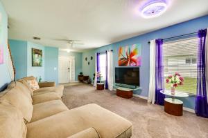 a living room with a couch and a tv at Sunny Wesley Chapel Home about 2 Mi to Epperson Lagoon in Wesley Chapel