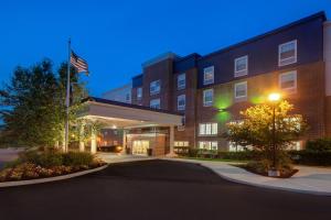 an exterior view of a hotel at night at Hampton Inn & Suites Yonkers in Yonkers