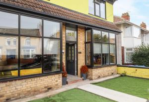 a house with large windows and a yard at The Yellow House in Withernsea