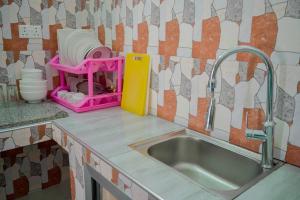 a kitchen counter with a sink and a mixer at MOYOWANGU HOUSE PAJE in Paje