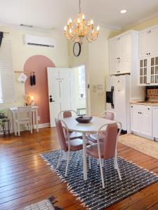 a kitchen and dining room with a table and chairs at 1885 Vintage Parlor Loft: Heart of Historic SAV in Savannah