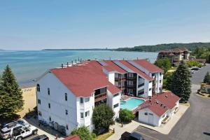 an aerial view of a building and the ocean at Beachside 109 with Direct Beach Access Pool and Hot Tub in Traverse City