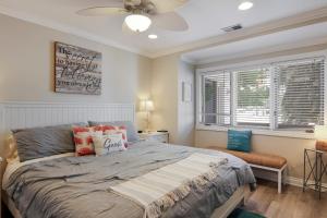 a bedroom with a large bed and a window at Beachside 109 with Direct Beach Access Pool and Hot Tub in Traverse City +22 photos