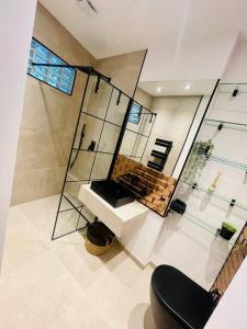 a bathroom with a glass walled shower and a toilet at Der Vitihof Loft in Osnabrück