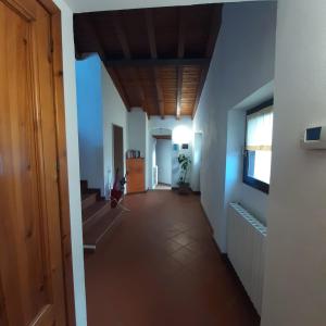 a hallway with blue walls and a wooden ceiling at Loft trabucco panoramico 4 camere 7posti letto vista lago e centro storico in Salò