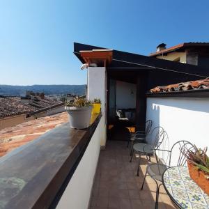 a balcony with chairs and tables on a roof at Loft trabucco panoramico 4 camere 7posti letto vista lago e centro storico in Salò