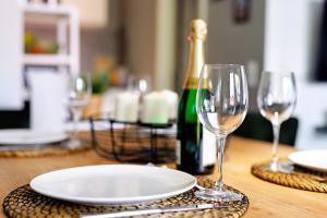 a table with two glasses and a bottle of wine at Peaceful City Apartment in Hamburg