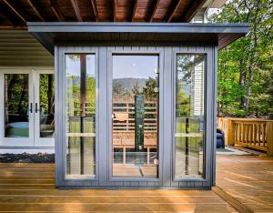 a screened in porch with sliding glass doors at Mtn Views - Sauna - Hot Tub - Health - Wellness in Massanutten