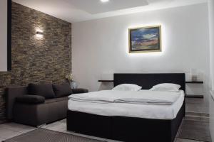 a bedroom with a bed and a couch at Črni Baron Pension Black Baron in Maribor +96 photos