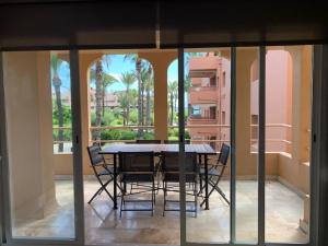 a dining room with a table and chairs on a balcony at Charming 3 Bedroom apartment with sea view in the heart of Sotogrande in Sotogrande