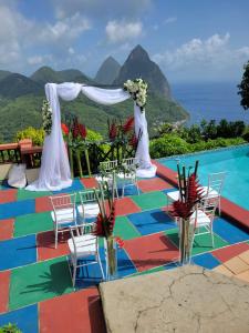 a wedding set up on a colorful floor next to a pool at Samfi Gardens in Soufri&egrave;re