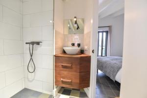 a bathroom with a sink and a shower at Casa de Piedras by SIERRA VIVA desing in Cortelazor