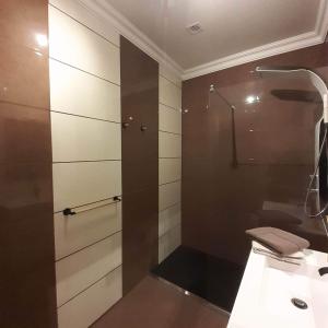 a bathroom with a glass shower and a toilet at A Flor da Rosa in Vila Nova de Foz Coa