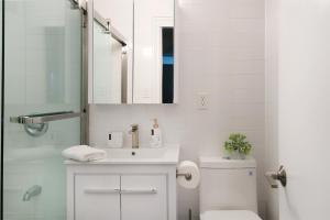 a bathroom with a sink and a toilet and a mirror at 444-3A Newly renovated 1BR - Elevator Building in New York