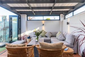 a living room with a couch and a table at Atlantic Beach Cottage in Langebaan