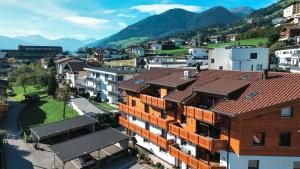 an aerial view of a city with houses and mountains at AlpenLuxus' OLDWOOD CHALET with balcony & car park in Fügen