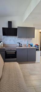 a kitchen with a stove and a counter top at Ferienwohnung Stoisser in Mureck