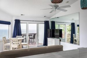 a living room with a couch and a flat screen tv at Beach 321 with Vaulted Ceilings Pool Hot Tub and Stunning Views from Private Deck in Traverse City