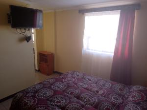 a bedroom with a bed and a window at sleep easy in Coquimbo