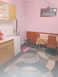 a kitchen with a table and a table and chairs at Casa Roxy in Cristian