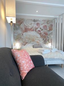 a bedroom with a bed with a flower mural at Esprit Romantique in Mulhouse