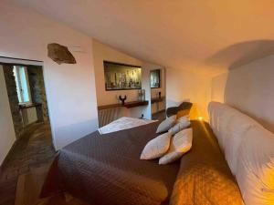 a bedroom with a large bed with pillows on it at Kiko's Lodge - Historical Apartment in Como in Como