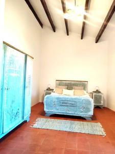 a bedroom with a blue bed in a room at Mas Fina in Palafrugell +35 photos
