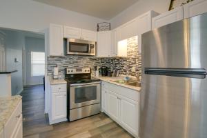 a kitchen with white cabinets and a stainless steel refrigerator at Centrally Located Memphis House 2 Mi to Beale St! in Memphis