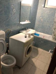 a bathroom with a toilet and a sink at Amazing Apartments in Bucharest