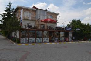 a building with an umbrella on the side of a street at Erciyes Stone Hotel in Uçhisar