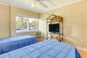 a bedroom with a bed and a flat screen tv at Welcoming Sarasota Vacation Rental with Pool! in Sarasota