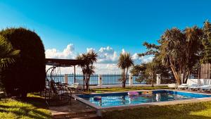 a swimming pool with a view of the water at Natalia Guest House in Batumi