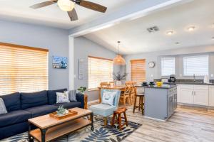 a living room with a blue couch and a kitchen at 102 10th St. in Saint Augustine Beach