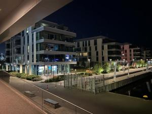 a night view of a building in a city at Modern Vero Apartments Yacht Park in Gdynia