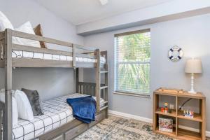 a bedroom with two bunk beds and a window at 102 10th St. in Saint Augustine Beach