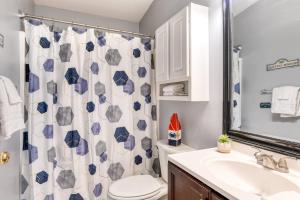 a bathroom with a toilet sink and a shower curtain at 102 10th St. in Saint Augustine Beach +39 photos