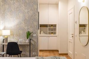 a bedroom with a desk and a chair and a mirror at 94Rooms Vatican Guest House- Scipioni in Rome