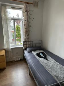 a bedroom with a bed and a window at Affordable Private Rooms in Wembley in London