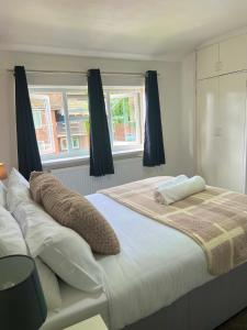 a bedroom with a large bed with black curtains at The Ultimate Home Away from Home in Birmingham