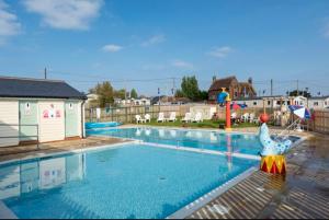a large swimming pool with a toy duck in the middle at Staycay Luxury Caravan in Seasalter