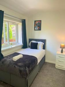 a bedroom with a large bed with a window at The Ultimate Home Away from Home in Birmingham