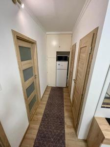 a hallway with two doors and a washer and dryer at LOVEly Home&Lake in Balatonfüred