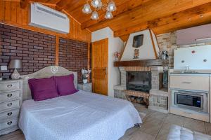 a bedroom with a bed and a fireplace at Montevrain Cottage in Montévrain