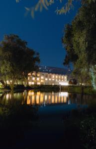 a building at night with a lake in front of it at BTH Hotel Arequipa Lake in Arequipa