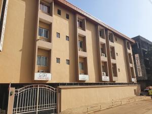 a large building with a gate in front of it at Hotel du Golfe de Guinee in Conakry