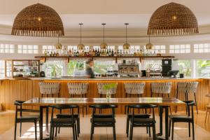 a restaurant with a table and chairs and a bar at Sonder The Deco in Miami Beach
