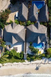 an aerial view of a house with roofs at Bitcoin Beach Hotel Zanzibar in Pingwe