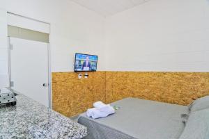 a room with a bed with a towel on it at Vila 50 Hospedagem in Sao Paulo